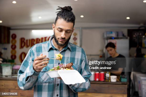 man eating enchiladas at a small mexican restaurant - street taco stock pictures, royalty-free photos & images