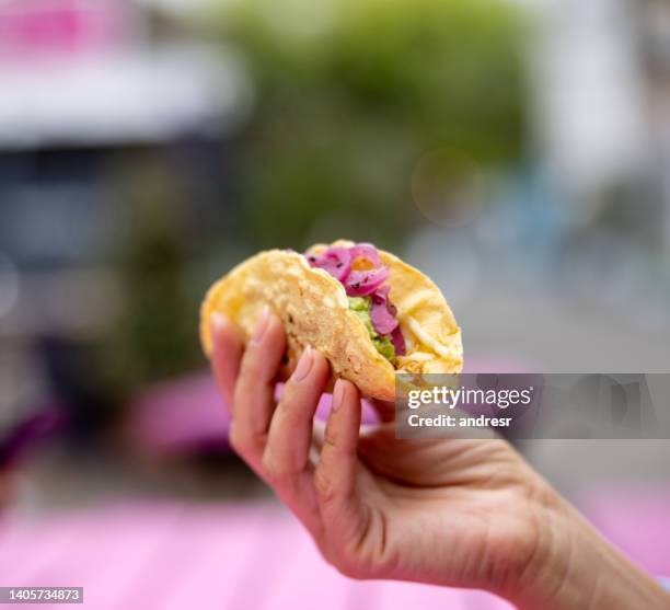 close-up on a woman eating a taco at a mexican restaurant - tacos bildbanksfoton och bilder