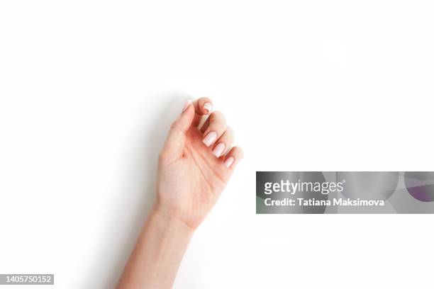 hand with pink manicure on white background, top view. - nail varnish stockfoto's en -beelden