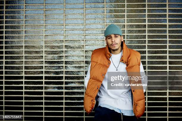 urban portrait of serious young hispanic man - ski vest stock pictures, royalty-free photos & images