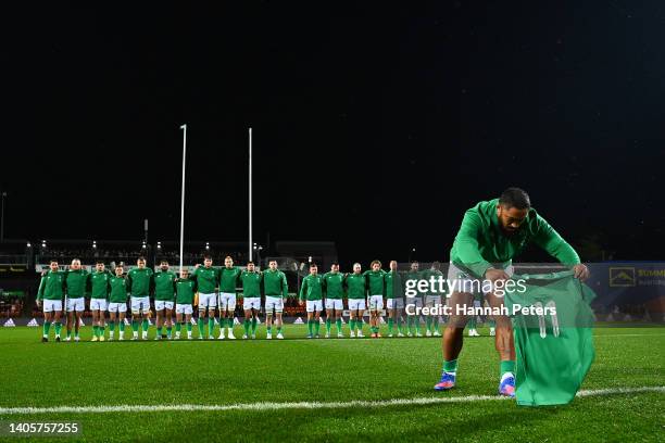 Bundee Aki of Ireland presents an Ireland jersey to the family of the late Sean Wainui before the match between the Maori All Blacks and Ireland at...