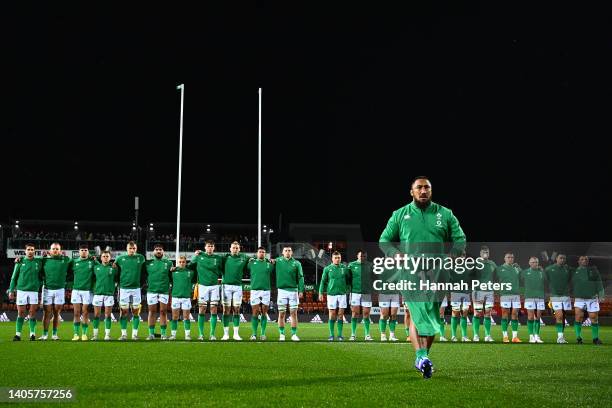 Bundee Aki of Ireland presents an Ireland jersey to the family of the late Sean Wainui before the match between the Maori All Blacks and Ireland at...
