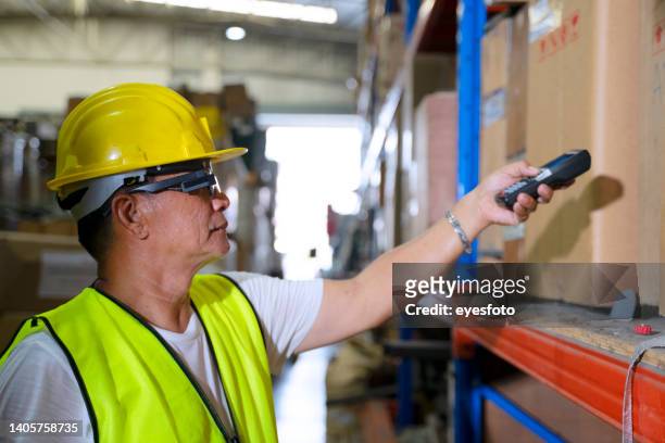 blue collar worker with co worker at factory. - smart glasses stock pictures, royalty-free photos & images