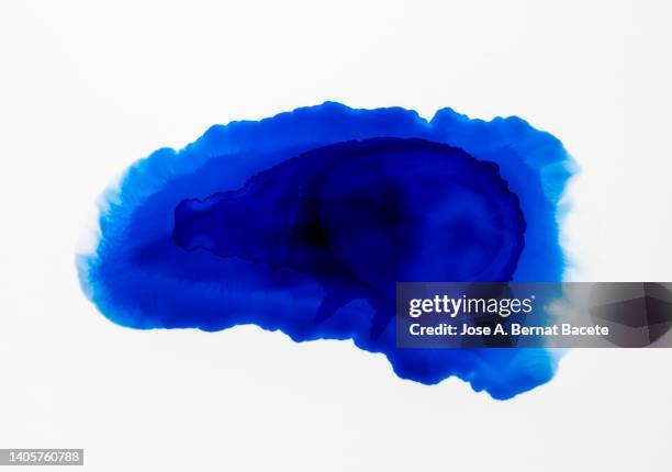 splashes of a drop of blue paint on a white canvas. - paper falling stock pictures, royalty-free photos & images
