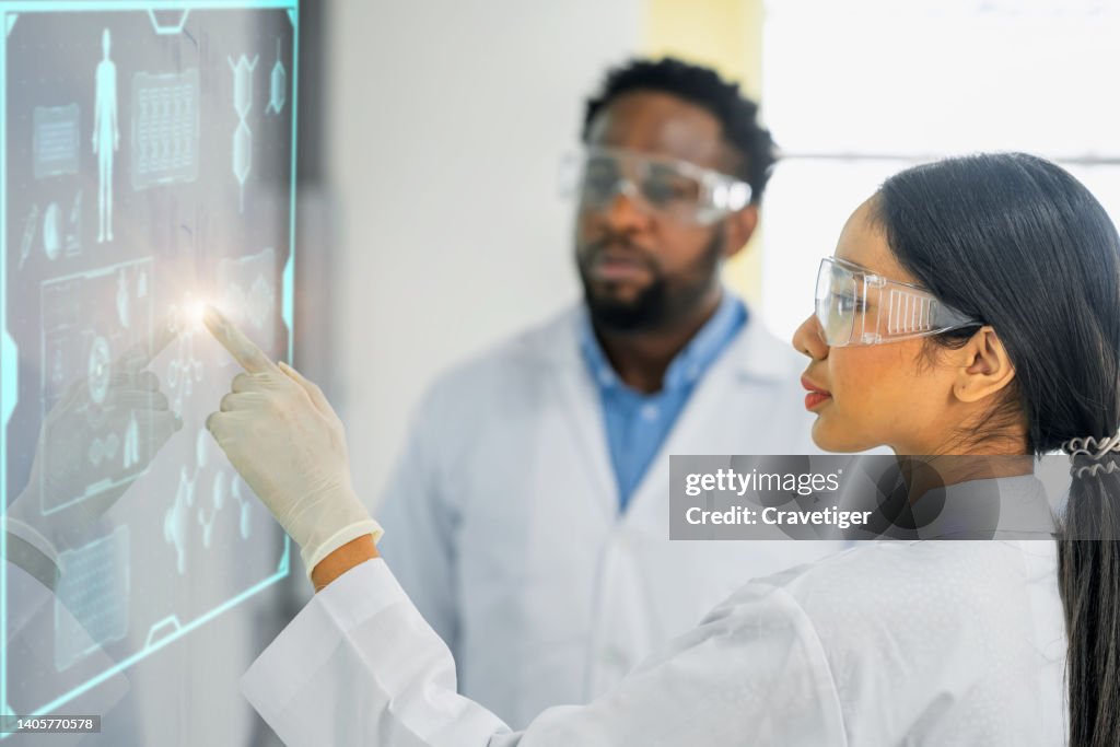 Female chemical engineering Shows biological and chemical digitization display, and a Team of chemical engineering, Doctors Discuss formulas, Drug Research, Medicine Development in laboratory.