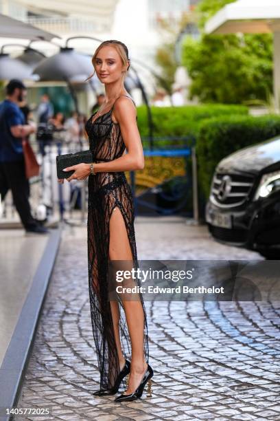 Guest wears a gold long necklace, a black tulle with embroidered sequined / pearls V-neck / tank-top / slit / split long dress, a black sequined...