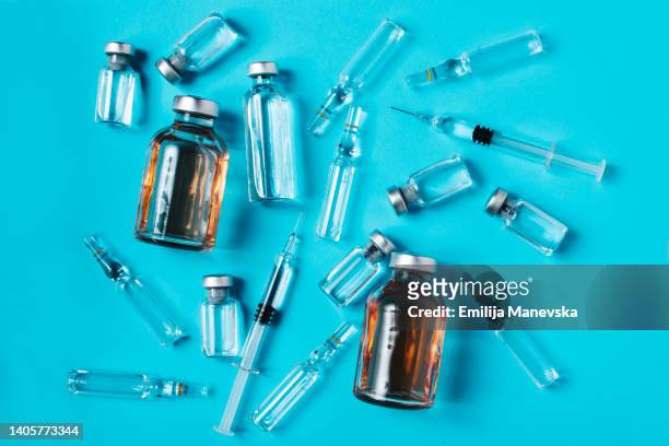 glass bottles, ampules and syringe with needle - antibiotic resistance stock pictures, royalty-free photos & images