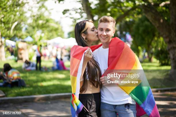 young adult female couple at pride parade - photos of lesbians kissing stock pictures, royalty-free photos & images
