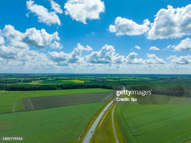road through a forest seen from above - drenthe stock pictures, royalty-free photos & images