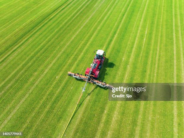 tractor injecting livestock liquid manure with in a field - animal dung stock pictures, royalty-free photos & images