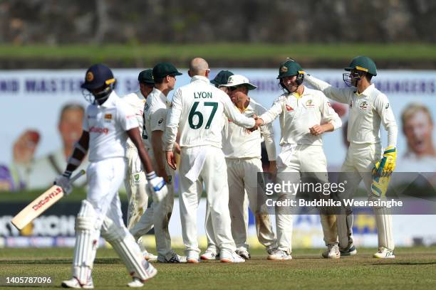 Australian players celebrate after dismissing Lasith Embuldeniya of Sri Lanka during day one of the First Test in the series between Sri Lanka and...