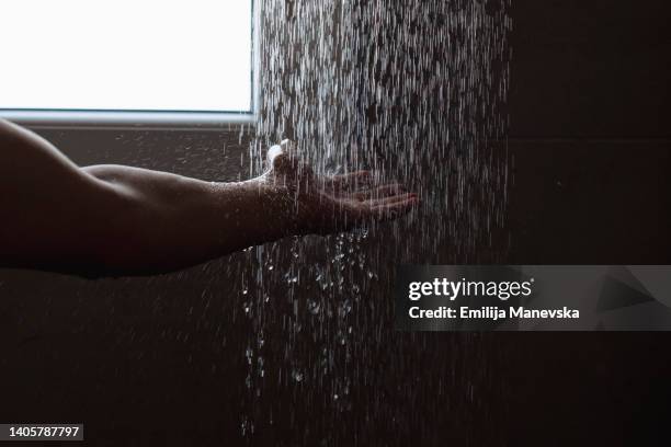 close up of man hands beneath shower of water - flowing water stock pictures, royalty-free photos & images