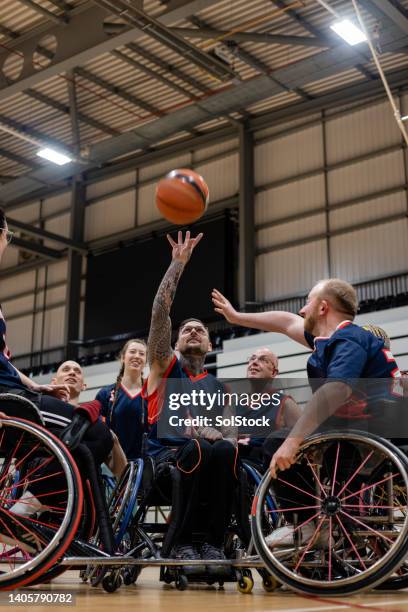 basketball team in action - wheelchair basketball team stock pictures, royalty-free photos & images