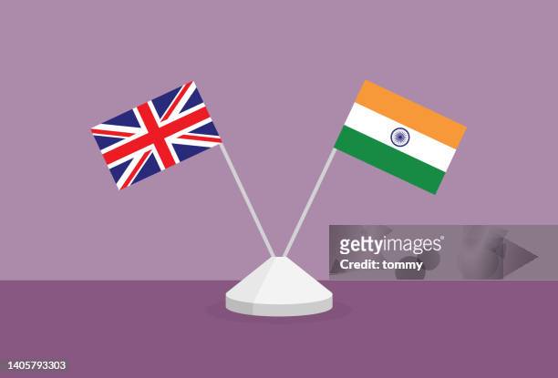 britische und indische flagge auf einem tisch - indische flagge stock-grafiken, -clipart, -cartoons und -symbole