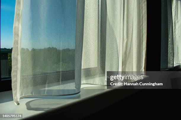 soft curtains draped infront of a sunny window - close up - window sill 個照片及圖片檔