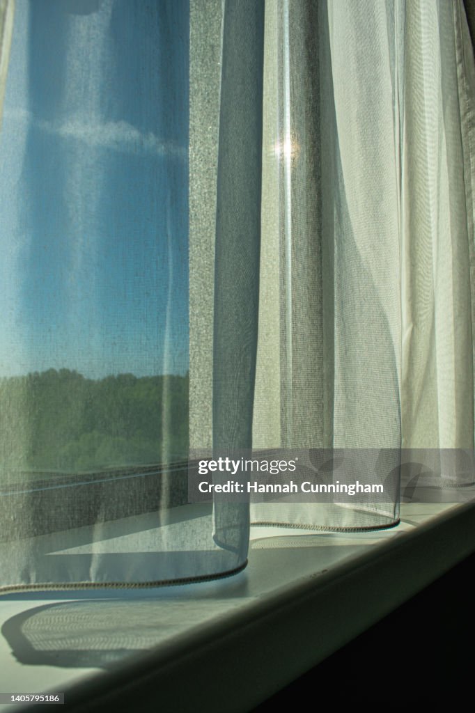 Soft Curtains Draped infront of a Sunny Window