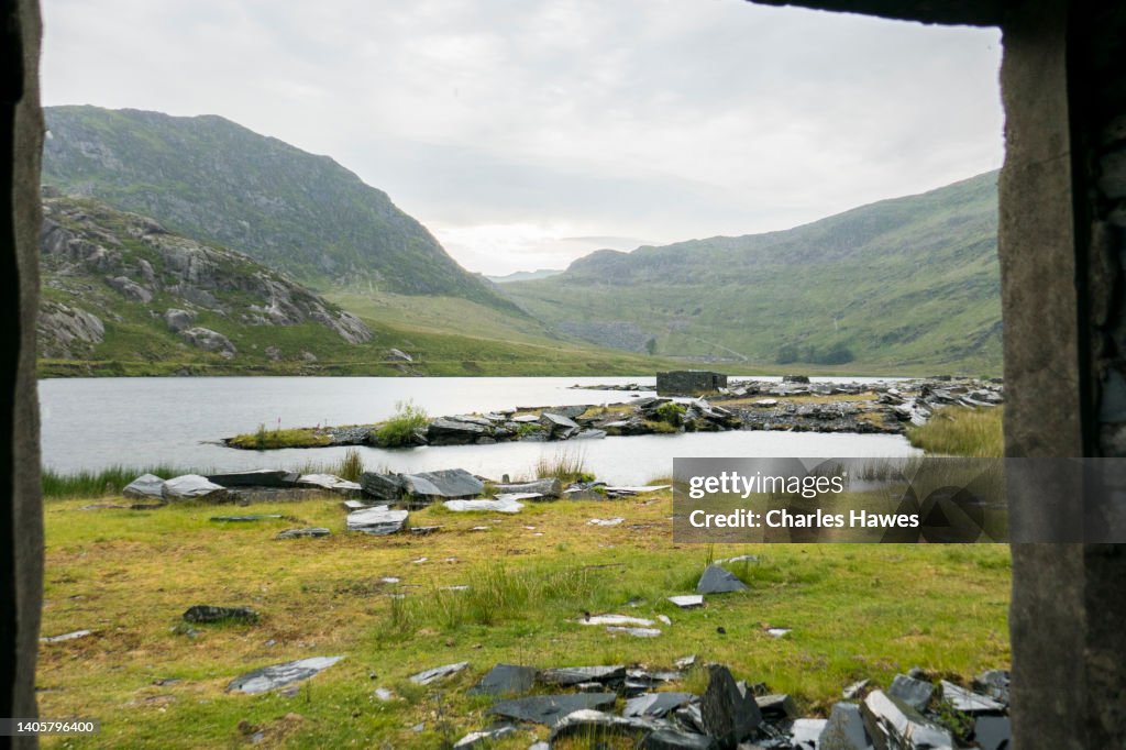 View over Llyn Cwmorthin from within outbuilding; Views of Cwmorthin quarry near Blaenau Ffestiniog, Gwynedd, North Wales. June