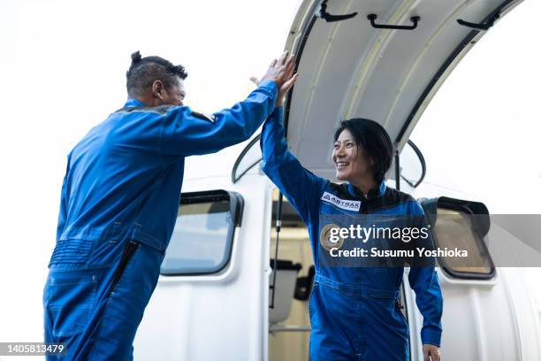 commercial space traveler getting off the spaceship. - flight suit stock pictures, royalty-free photos & images