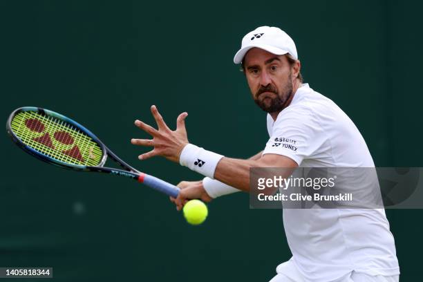 Steve Johnson of United States of America plays a forehand against Ryan Peniston of Great Britain during their Men's Singles Second Round match on...