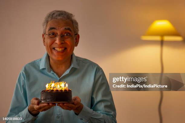 sad senior man celebrating his birthday at home - senior birthday stock pictures, royalty-free photos & images