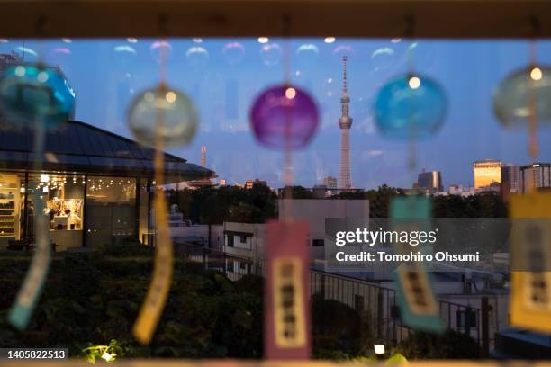 The Tokyo Skytree is seen through glass wind-bells during a preview of the Asakusa Yokocho alley on June 29, 2022 in Tokyo, Japan. The newly-built...