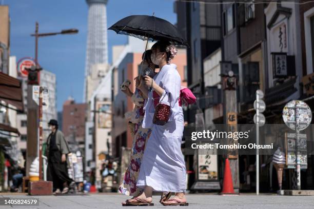 Women in rental kimonos walk through the Asakusa area on June 29, 2022 in Tokyo, Japan. The newly-built Asakusa Yokocho restaurant gathering facility...