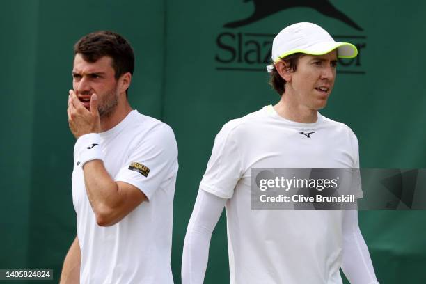 John-Patrick Smith of Australia interacts with partner Pedro Martinez of Spain during their Men's Doubles First Round match against Andrey Golubev of...