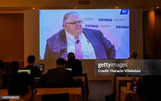 Journalists follow onscreen the remarks of the General Manager of Bank for International Settlements Agustín Carstens in the afternoon panel during...