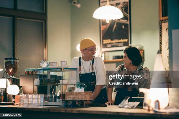 portrait of two young business owners in a cafe - busy coffee shop stock pictures, royalty-free photos & images