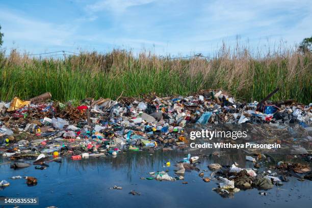 close up large garbage pile near the sunset, global warming - inquinamento causato dalla plastica foto e immagini stock