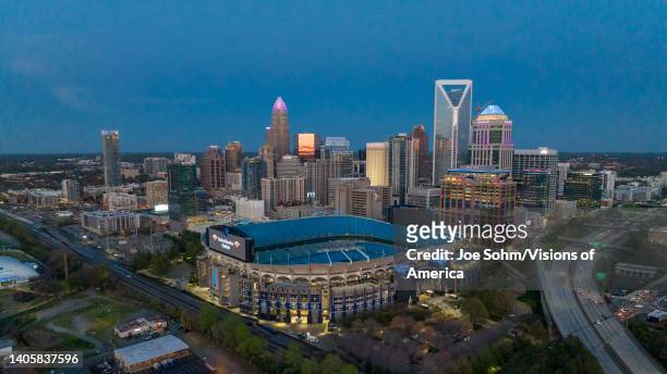 Aerial View of Charlotte, North Carolina at dusk on clear day showing highways and skyline.