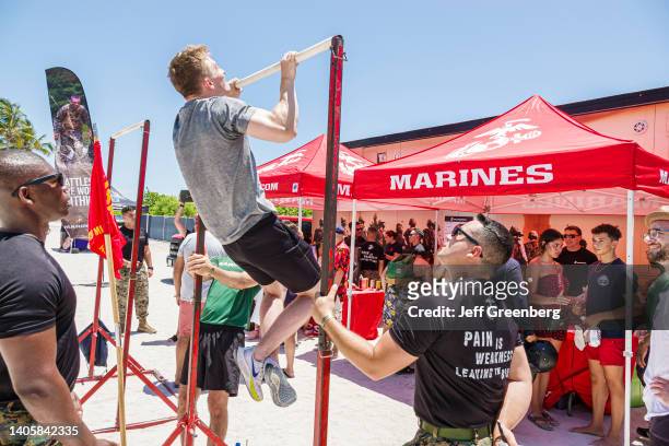 Miami Beach, Florida, Hyundai Air & Sea Show, Military Village vendor, Marines pull-up strength test challenge, men competing.