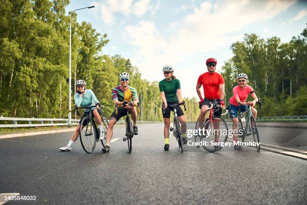 friends with road bicycle standing on road - cycling team stock pictures, royalty-free photos & images