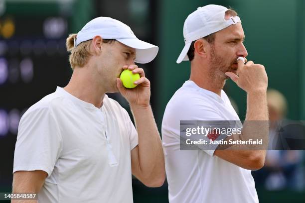 Matwe Middelkoop of Netherlands and partner Luke Saville of Australia interact during their Men's Doubles First Round match against Joao Sousa of...