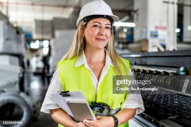 portrait of female engineer working in factory - best female act stock pictures, royalty-free photos & images