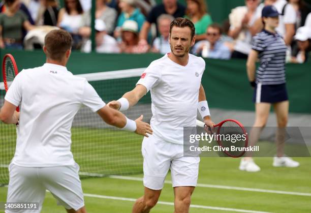 Neal Skupski of Great Britain and partner Wesley Koolhof of Netherlands interact during their Men's Doubles First Round match against Facundo Bagnis...