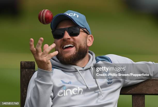 Brendon McCullum of England smiles as he tosses a ball during a training session before Friday's Test against India at Edgbaston on June 29, 2022 in...