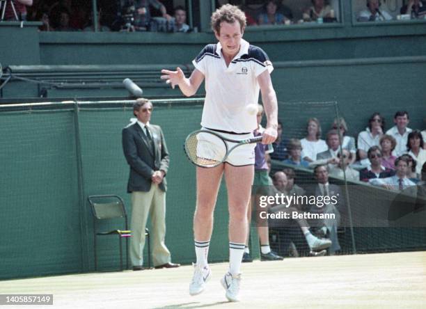 John McEnroe in action in the men's singles final against fellow American Jimmy Connors at Wimbledon. McEnroe leads 6-1, 6-1 in the first two sets.