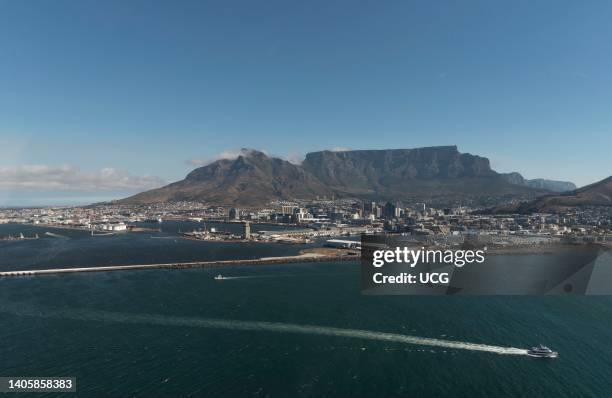 Cape Town South Africa, Aerial view of Table Mountain and city of Cape Town . In foreground passenger ferry bound for Robben Island.