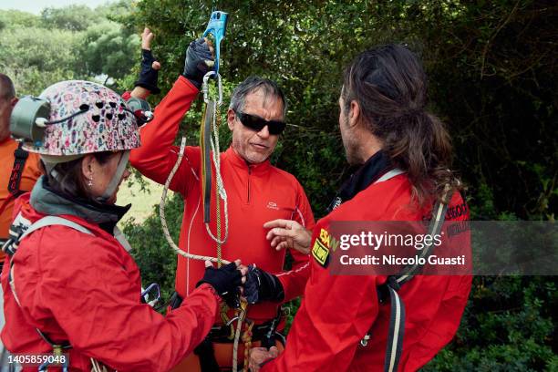 Alberto Molinos, who is blind, hold a handled ascender as he listen to speleologist who explain him how to use it on May 21, 2022 in Cortes de la...