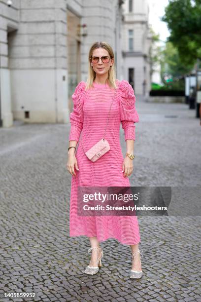 Tamara von Nayhauss wearing a long pink crochet dress with puffy sleeves by Ulla Johnson, a light pink mini bag by Chanel, a gold and black bracelet...