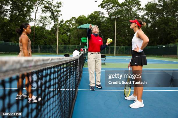 An umpire talks to Central Oklahoma Bronchos and the Barry Buccaneers before starting a singles match during the Division II Women"u2019s Tennis...