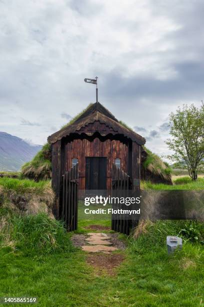 grafarkirkja turf church is made from timber and turf and surrounded by a circular turf wall, it looks like a jewel in the surrounding landscape - turf stock pictures, royalty-free photos & images