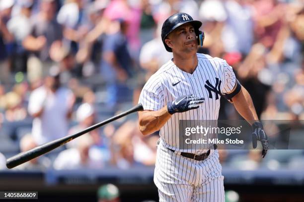Giancarlo Stanton of the New York Yankees flips his bat after hitting a 3-run home run to right field in the third inning Oakland Athletics at Yankee...