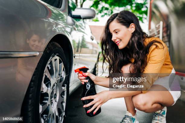 woman washing her car outdoors - auto detailing stock pictures, royalty-free photos & images