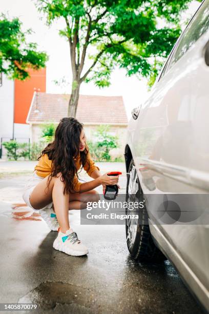 woman washing her car outdoors - auto detailing stock pictures, royalty-free photos & images