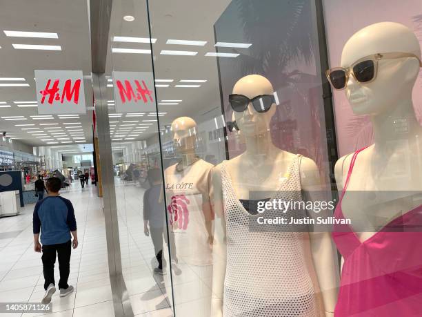 Shopper walks by a window display in an H&M store at Southland Mall on June 29, 2022 in Hayward, California. Swedish fashion retailer H&M reported a...