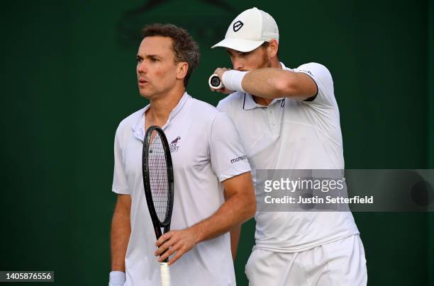 Jamie Murray of Great Britain interacts with partner Bruno Soares of Brazil against Benjamin Bonzi of France and Arthur Rinderknech of France during...