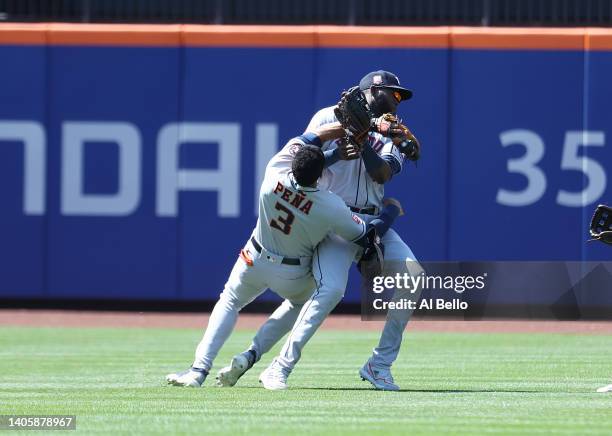 Jeremy Pena crashes into Yordan Alvarez of the Houston Astros while making a catch hit by Dominic Smith of the New York Mets in the eighth inning...