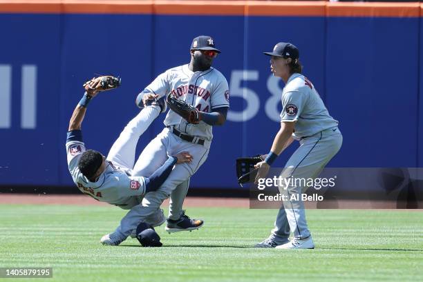 Jeremy Pena crashes into Yordan Alvarez of the Houston Astros while making a catch hit by Dominic Smith of the New York Mets in the eighth inning as...